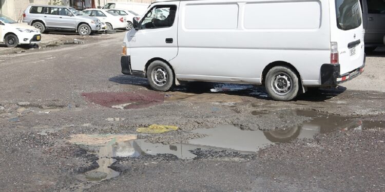 KUWAIT: A van navigates a potholed street. ??? Photo by Yasser Al-Zayyat