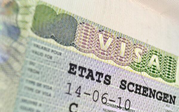 D2EEF4 passport page fragment with issued Schengen Visa; focus on VISA word